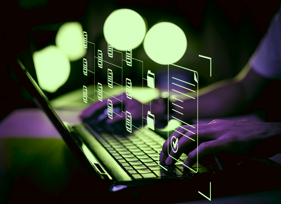 Closeup of a person typing on a laptop with a futuristic, floating, transparent display above it